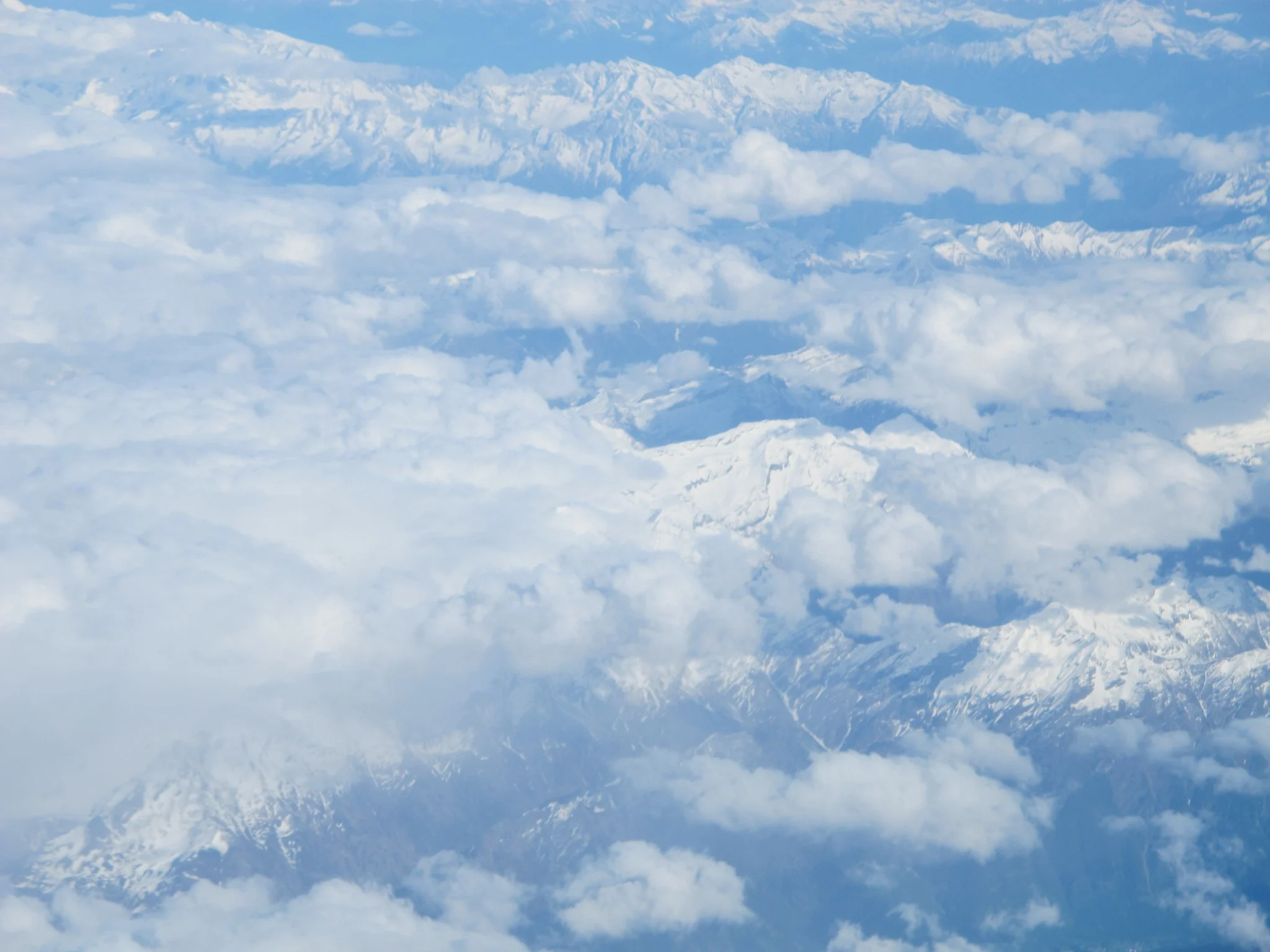 Snowy Alps seen above the clouds