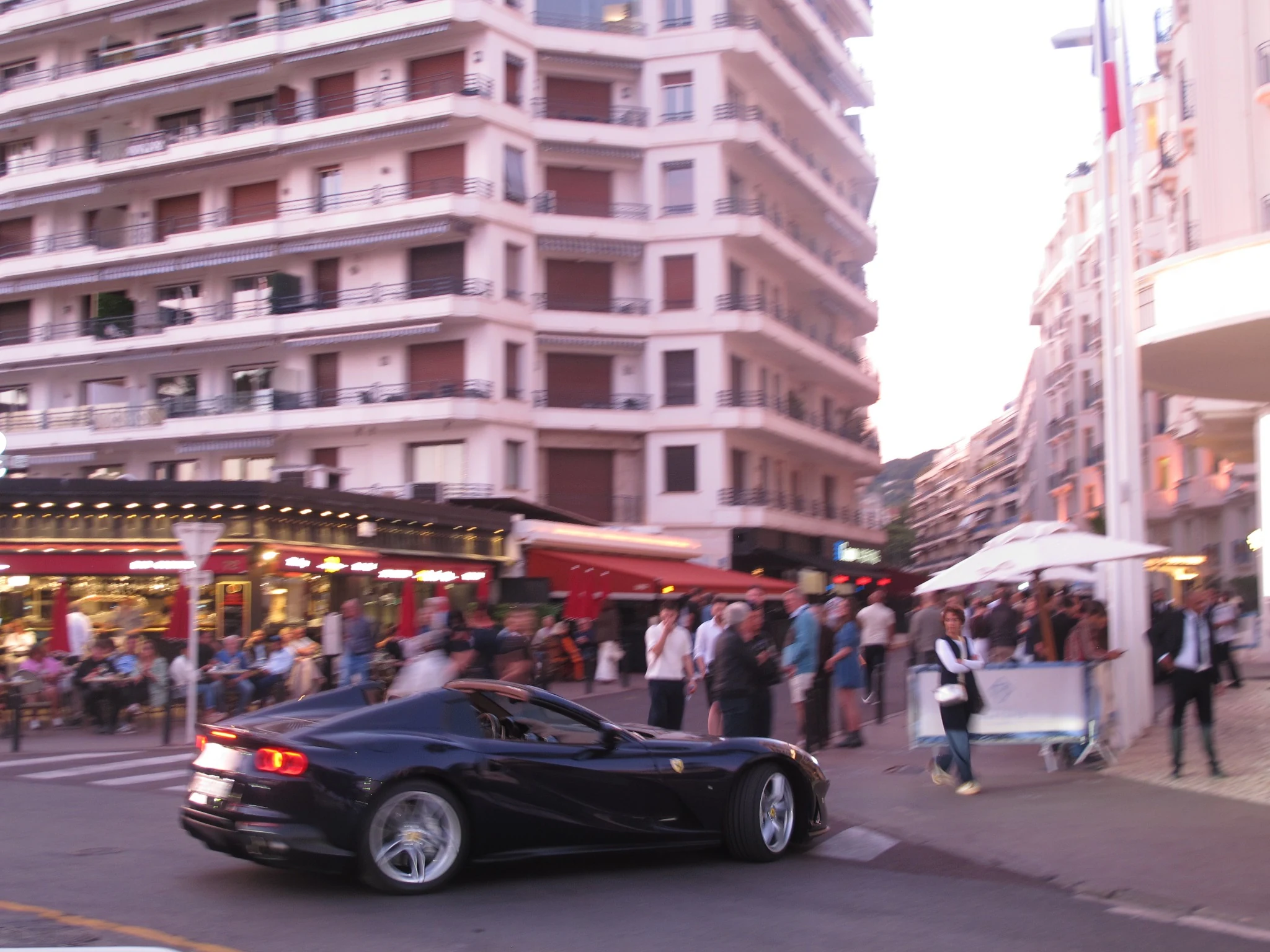 Black sports car in Cannes at dusk