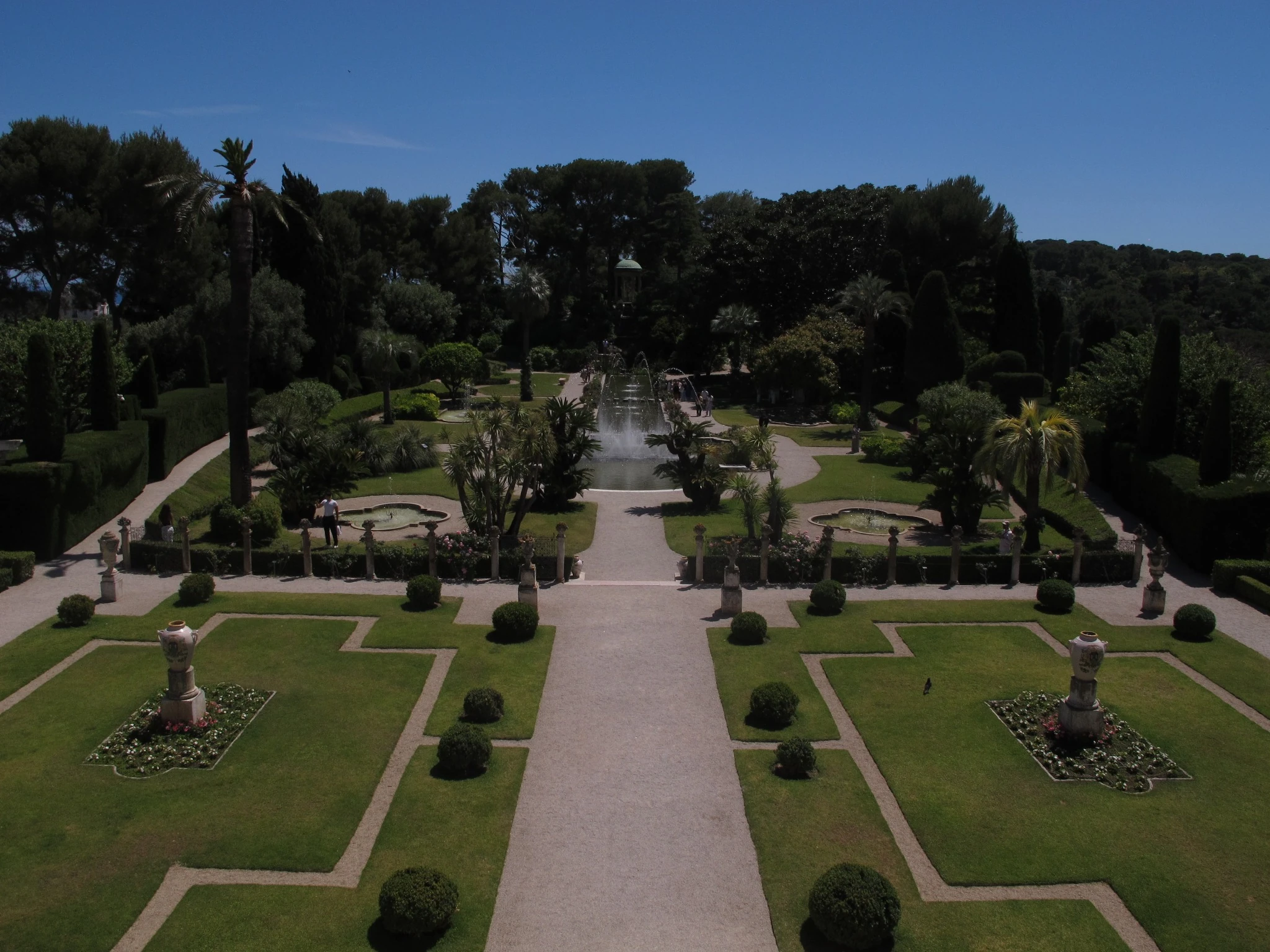 Formal French garden beneath a deep blue sky