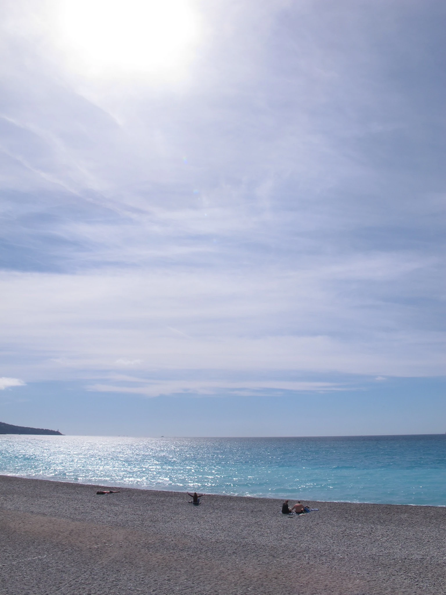 Bright Mediterranean beach beneath a wide blue sky