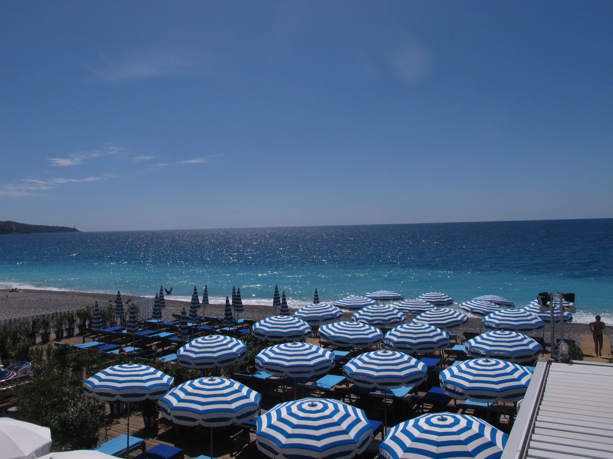 Blue and white parasols by the Mediterranean